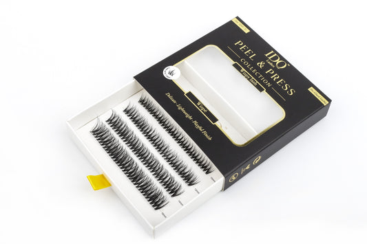 Box of false eyelashes with 'Peel & Press' branding on a white background